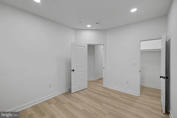 a view of a hallway with wooden floor