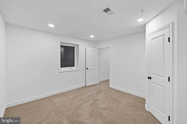 a view of a room with a sink cabinets and wooden floor