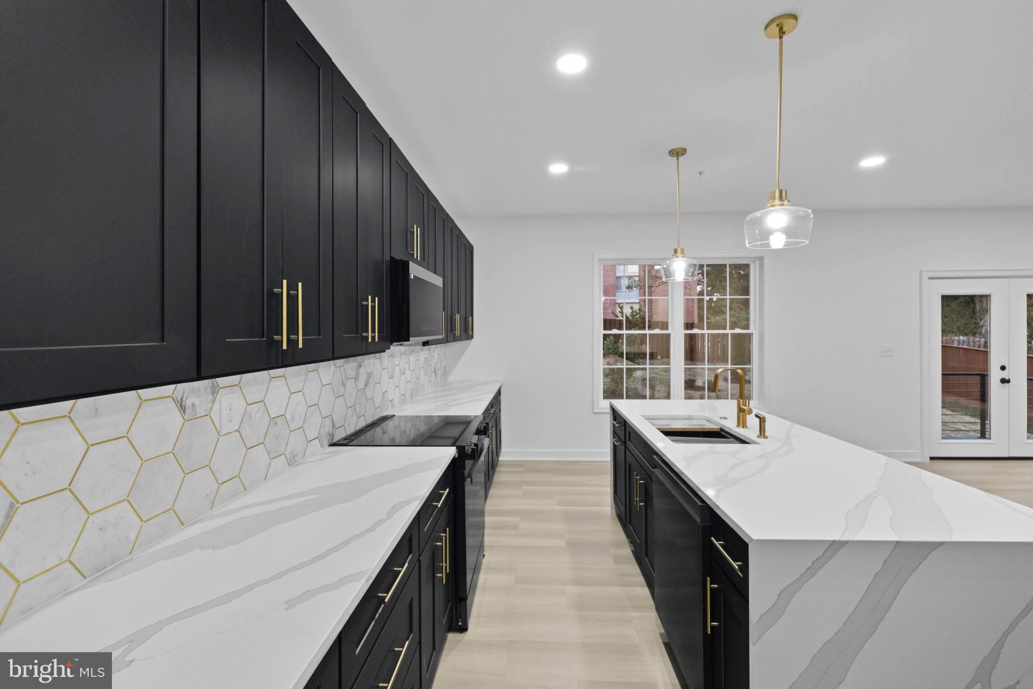 237 Brock Bridge Road Laurel, MD 20724 - Photo 4 of 64 a kitchen with stainless steel appliances kitchen island granite countertop a sink a stove and a wooden floors