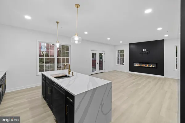 a kitchen with kitchen island a sink appliances and a counter top space