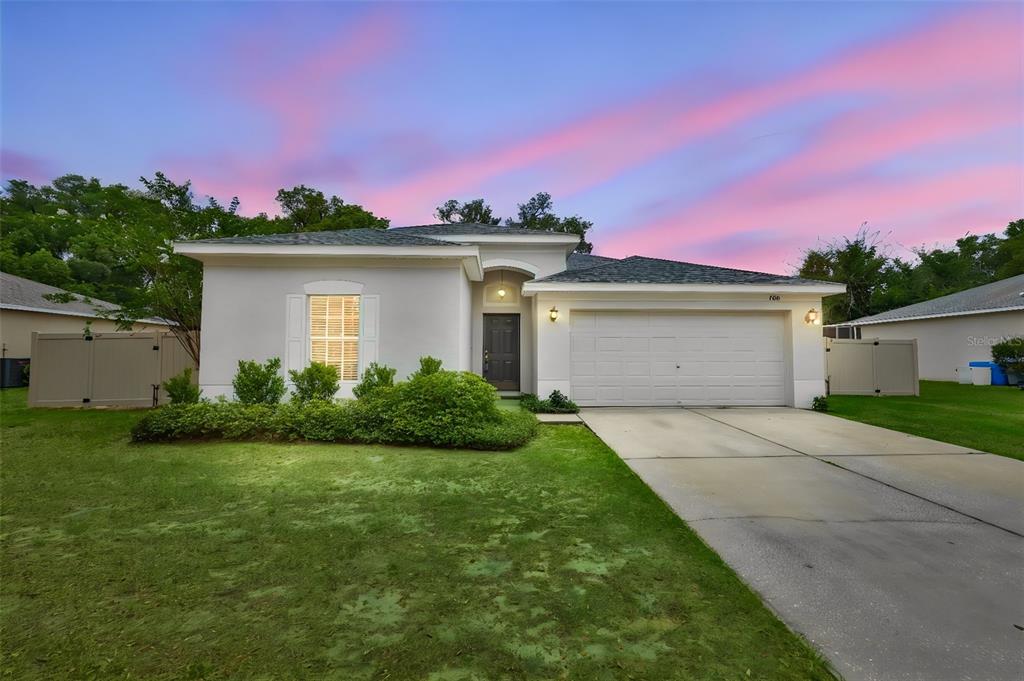 708 Coade Stone Drive Seffner, FL 33584 - Photo 1 of 48 a front view of a house with a yard and garage