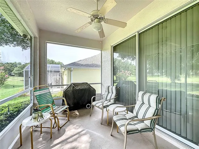 a living room with stainless steel appliances furniture a rug and a view of kitchen