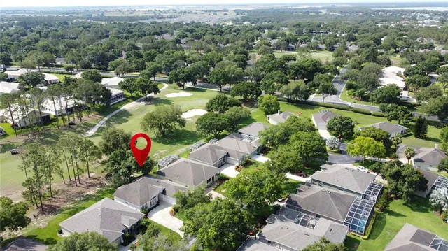 a kitchen with a table chairs refrigerator and cabinets