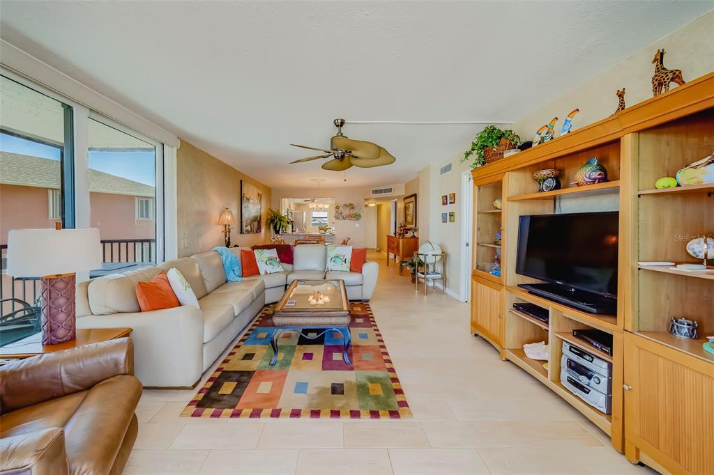 17580 Gulf Boulevard, Unit 412 Redington Shores, FL 33708 - Photo 14 of 67 a living room with furniture and a flat screen tv