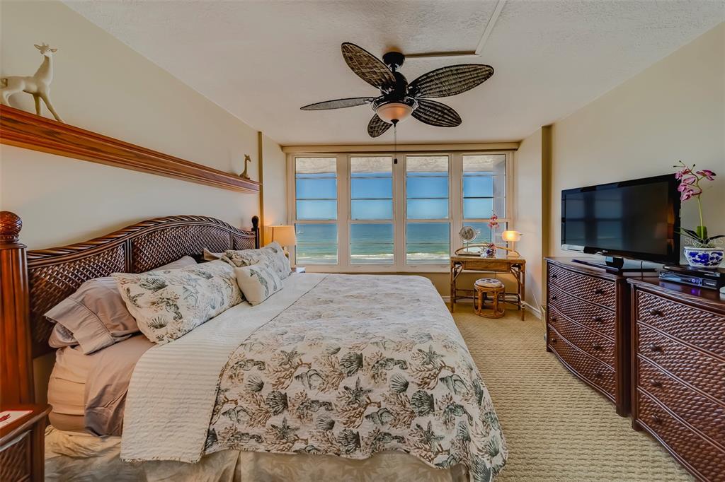 17580 Gulf Boulevard, Unit 412 Redington Shores, FL 33708 - Photo 26 of 67 a bedroom with a large bed and a flat tv screen