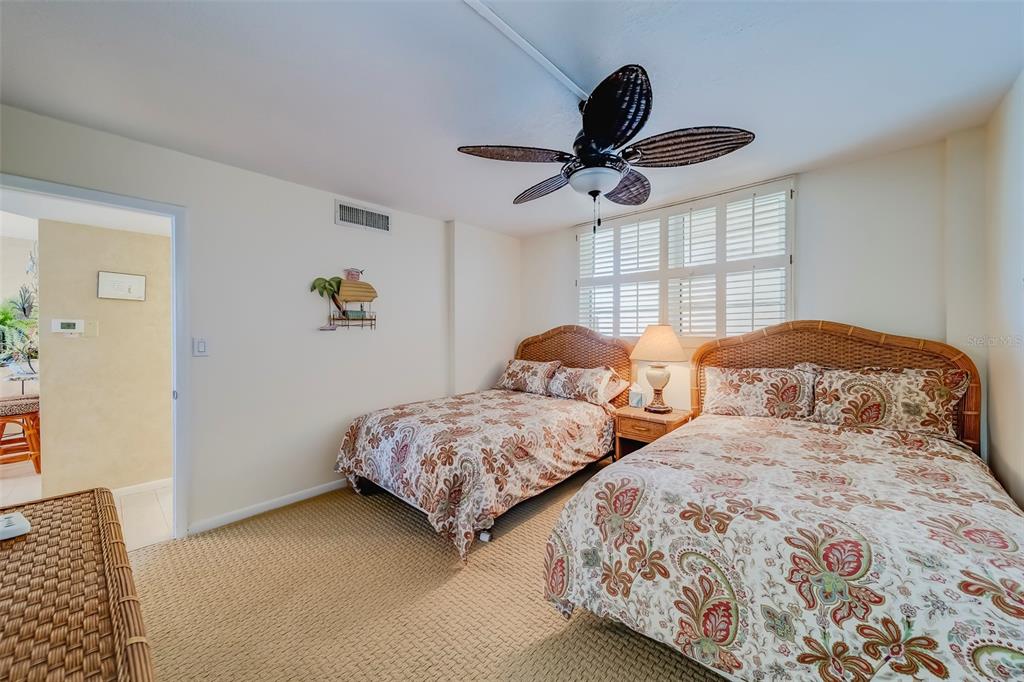 17580 Gulf Boulevard, Unit 412 Redington Shores, FL 33708 - Photo 35 of 67 a bedroom with two beds and a dresser