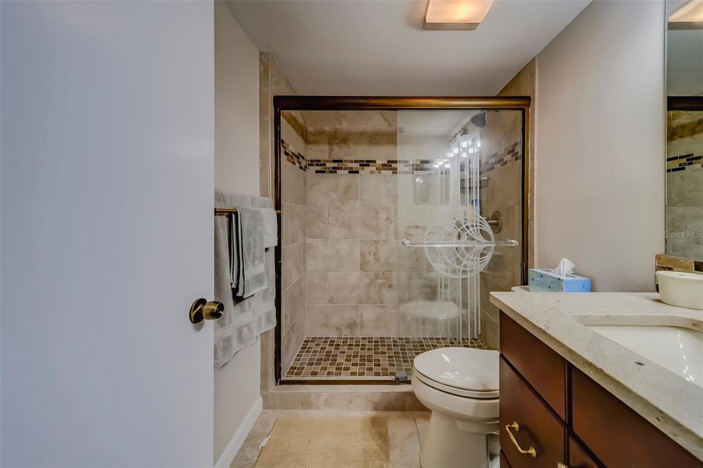 17580 Gulf Boulevard, Unit 412 Redington Shores, FL 33708 - Photo 36 of 67 a bathroom with a sink toilet and shower
