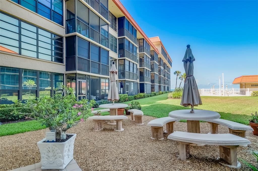 17580 Gulf Boulevard, Unit 412 Redington Shores, FL 33708 - Photo 43 of 67 a view of a building with garden and sitting area