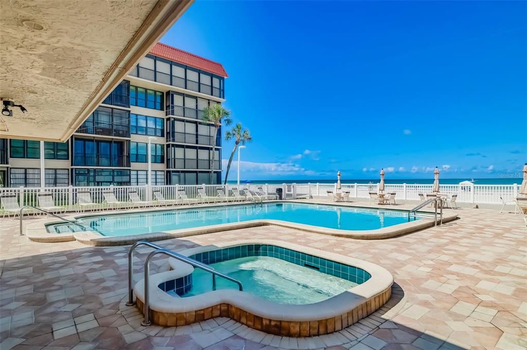 17580 Gulf Boulevard, Unit 412 Redington Shores, FL 33708 - Photo 49 of 67 a view of a swimming pool with a lounge chair