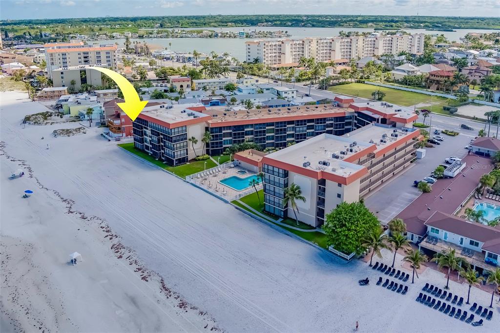 17580 Gulf Boulevard, Unit 412 Redington Shores, FL 33708 - Photo 59 of 67 a aerial view of a house with a swimming pool yard and outdoor seating