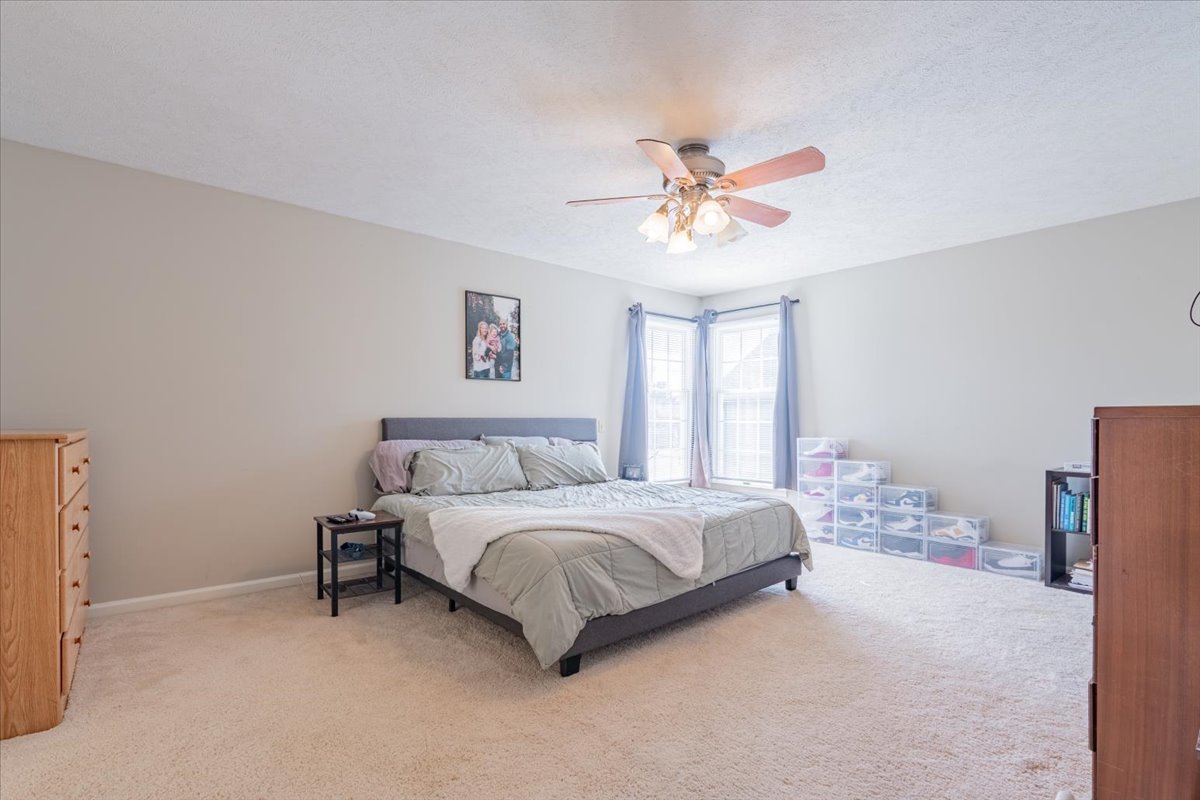 3 Downing Circle Bloomington, IL 61704 - Photo 21 of 47 a bedroom with a bed and a chandelier