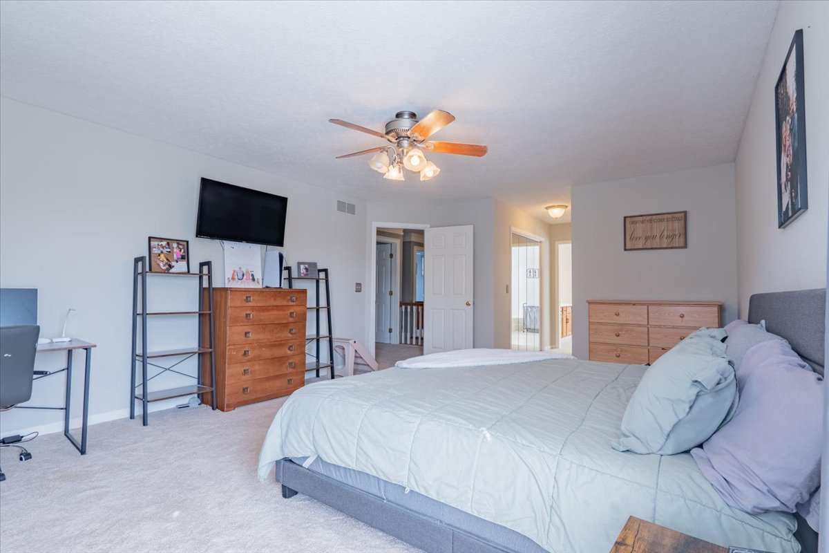 3 Downing Circle Bloomington, IL 61704 - Photo 22 of 47 a bedroom with a bed and a flat screen tv