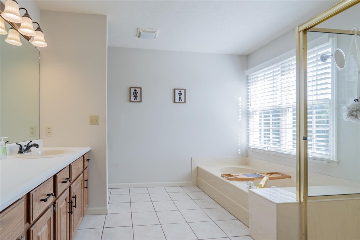 3 Downing Circle Bloomington, IL 61704 - Photo 23 of 47 a bathroom with a tub sink and mirror