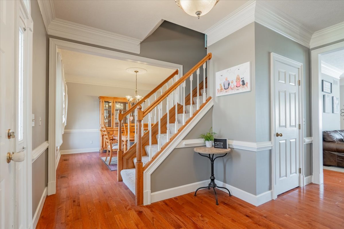 3 Downing Circle Bloomington, IL 61704 - Photo 3 of 47 a view of entryway with stairs and wooden floor