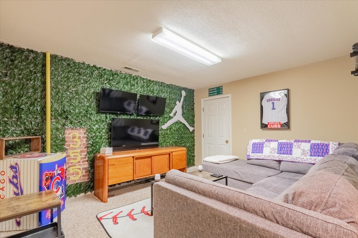 3 Downing Circle Bloomington, IL 61704 - Photo 32 of 47 a living room with furniture and a flat screen tv