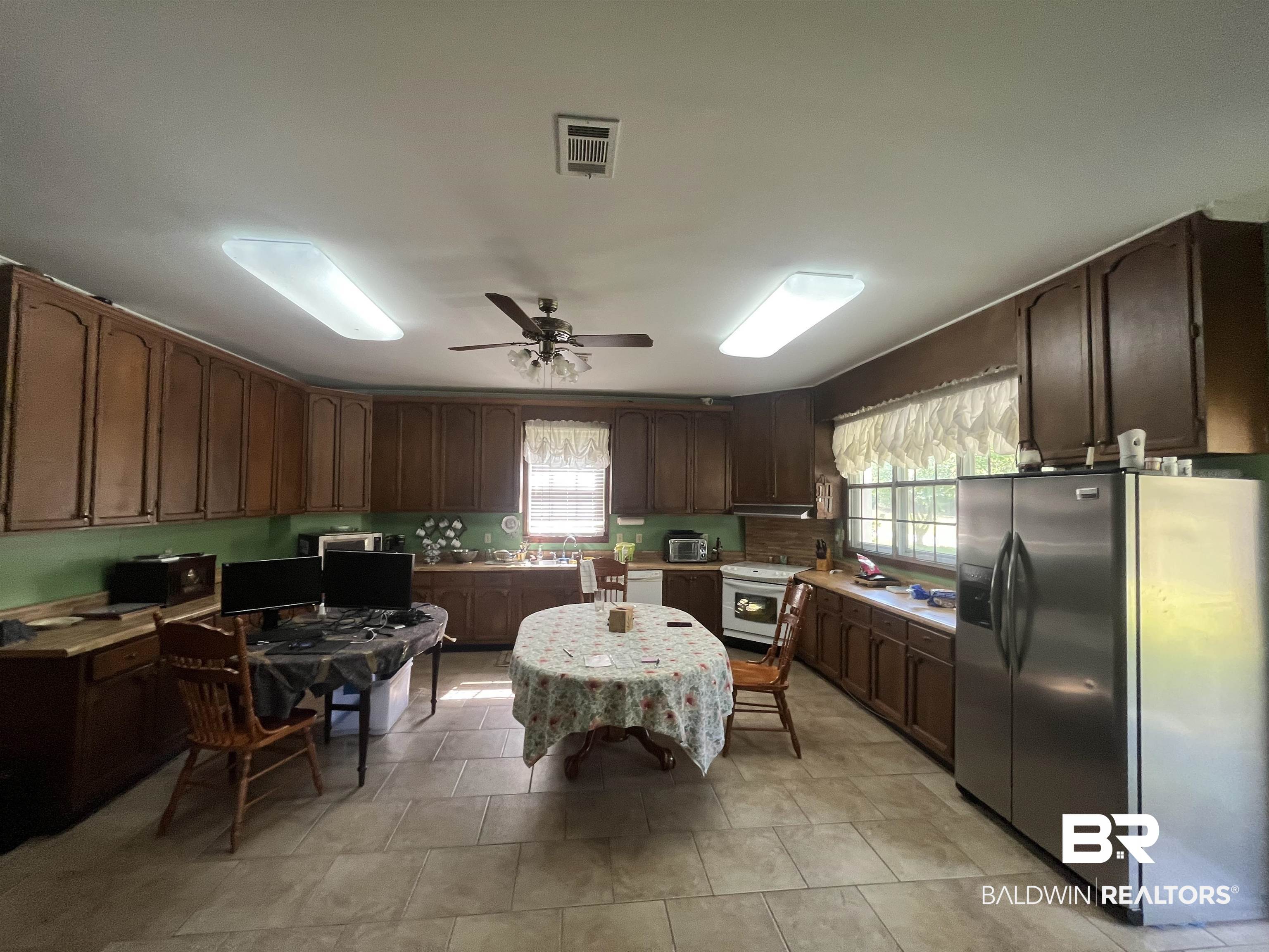 315 Dawkins Road Brewton, AL 36426 - Photo 11 of 19 Kitchen featuring ceiling fan, visible vents, white appliances, and light countertops