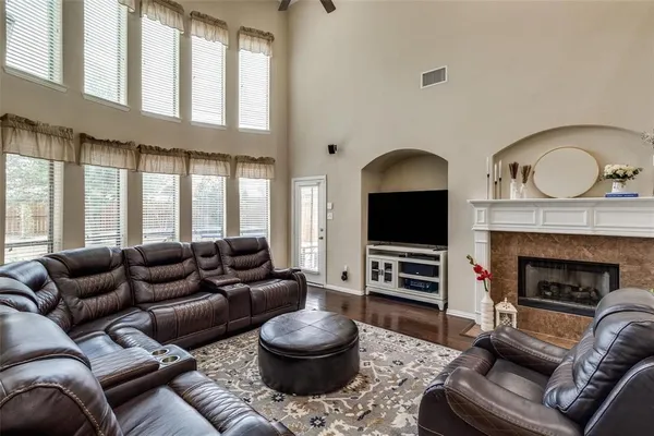 a living room with furniture a flat screen tv and a fireplace