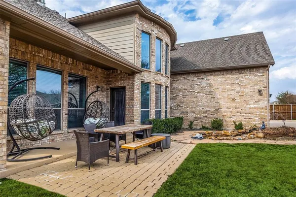 a backyard of a house with outdoor seating