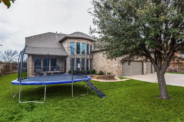a view of a house with a yard and sitting area