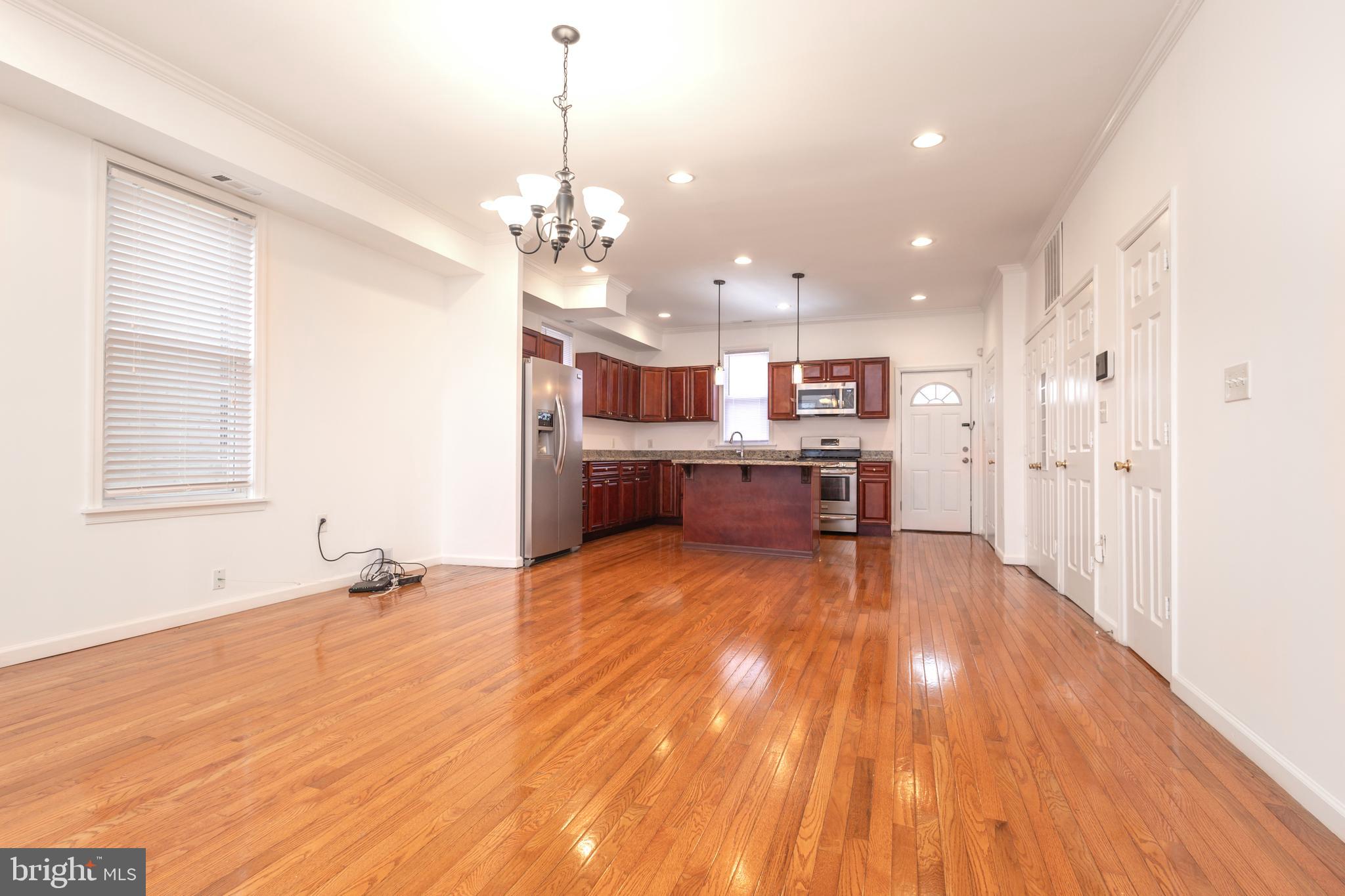 a view of a kitchen with microwave and cabinets