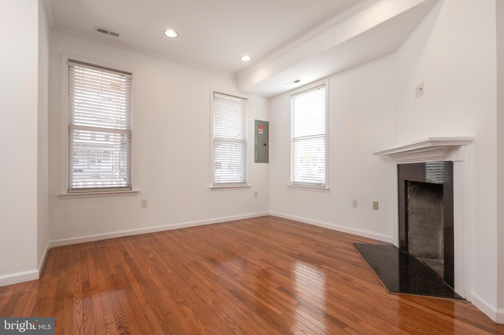 1911 17th Street Southeast Washington, DC 20020 - Photo 11 of 44 a view of empty room with wooden floor and fan