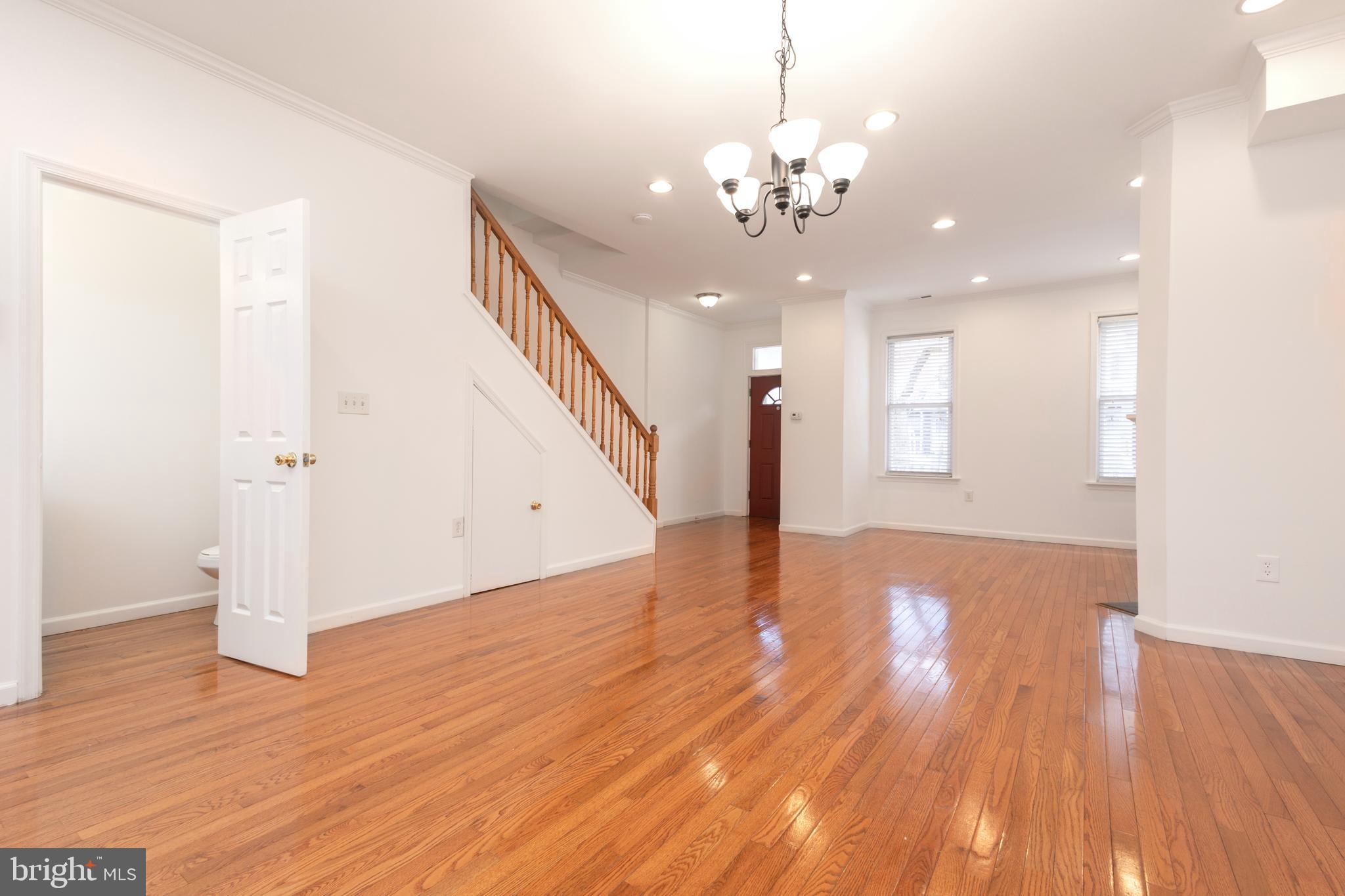 1911 17th Street Southeast Washington, DC 20020 - Photo 13 of 44 a view of a livingroom with wooden floor and staircase