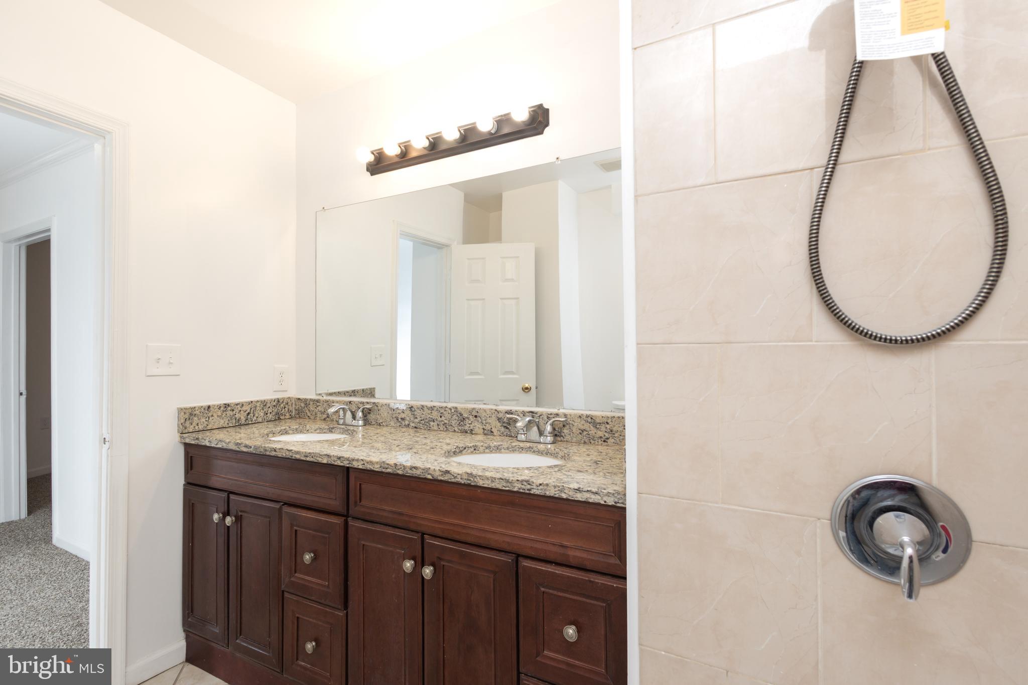 1911 17th Street Southeast Washington, DC 20020 - Photo 16 of 44 a bathroom with a sink and a mirror