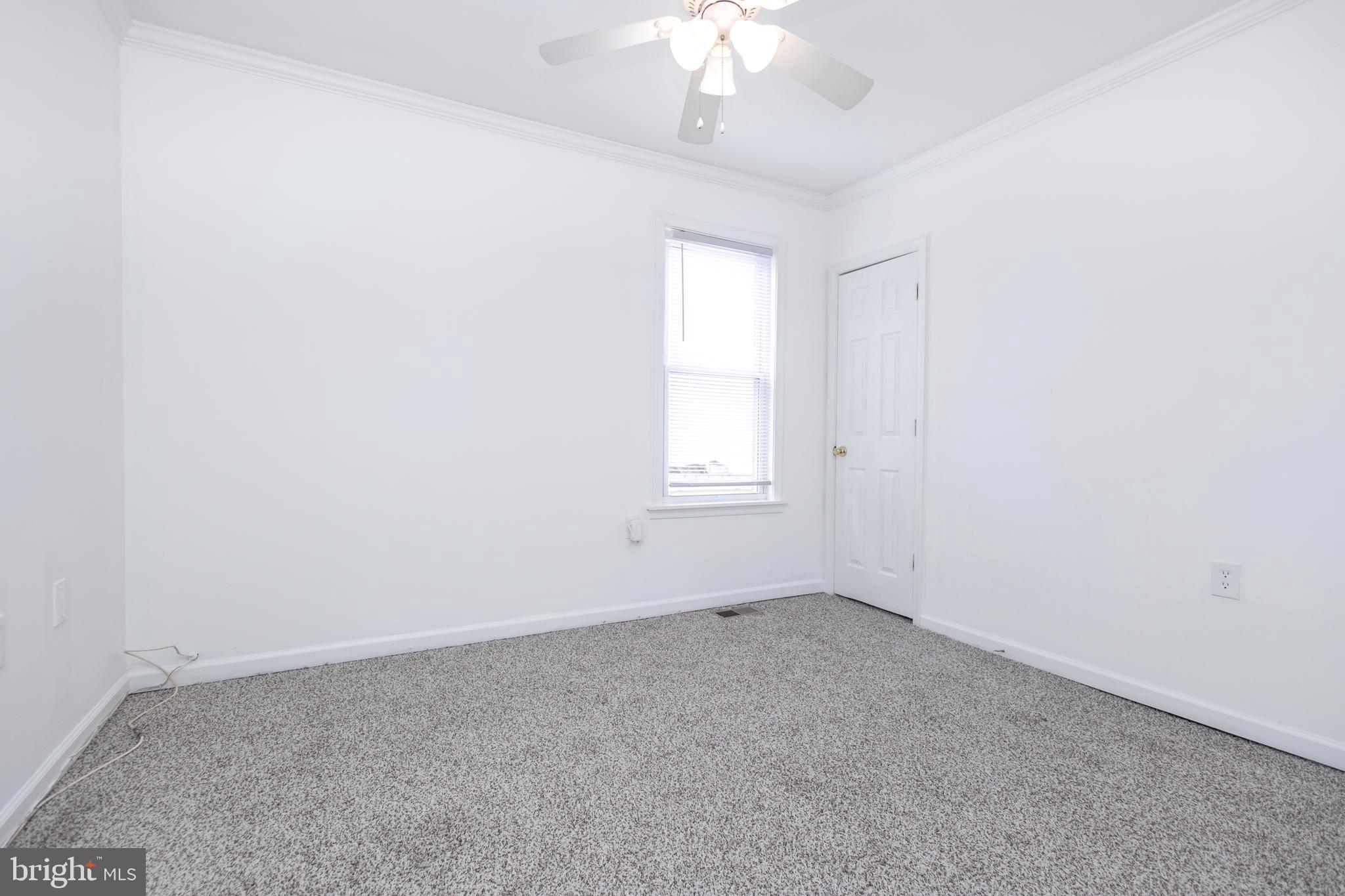 1911 17th Street Southeast Washington, DC 20020 - Photo 22 of 44 an empty room with a chandelier fan