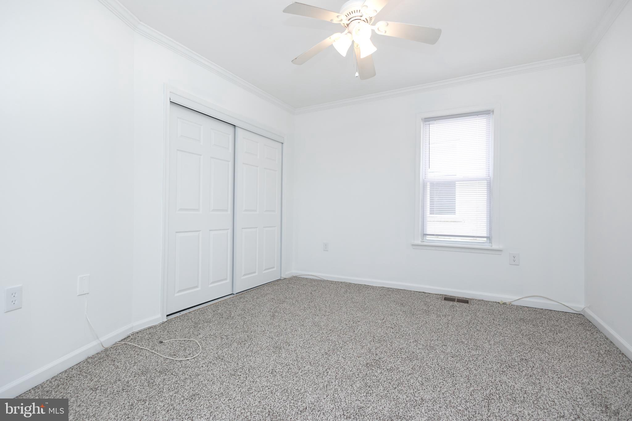 1911 17th Street Southeast Washington, DC 20020 - Photo 23 of 44 an empty room with a chandelier fan