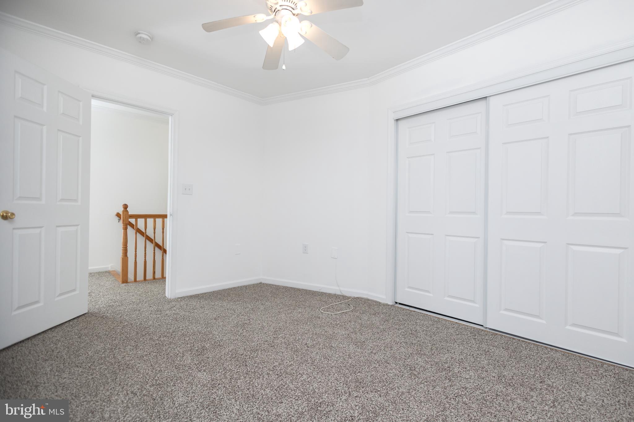 1911 17th Street Southeast Washington, DC 20020 - Photo 24 of 44 an empty room with a chandelier fan