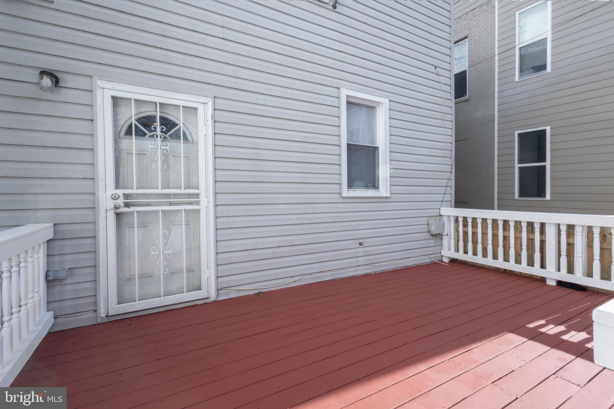 1911 17th Street Southeast Washington, DC 20020 - Photo 37 of 44 a view of a deck with wooden floor and a yard