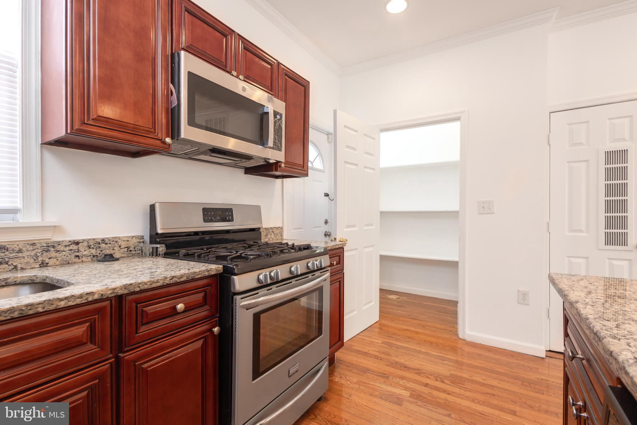 1911 17th Street Southeast Washington, DC 20020 - Photo 9 of 44 a kitchen with a stove and a microwave