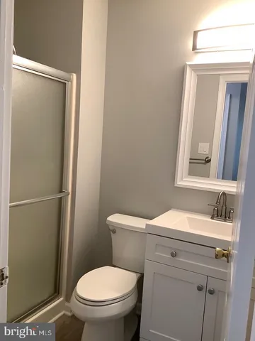 a bathroom with a toilet a sink a vanity and mirror