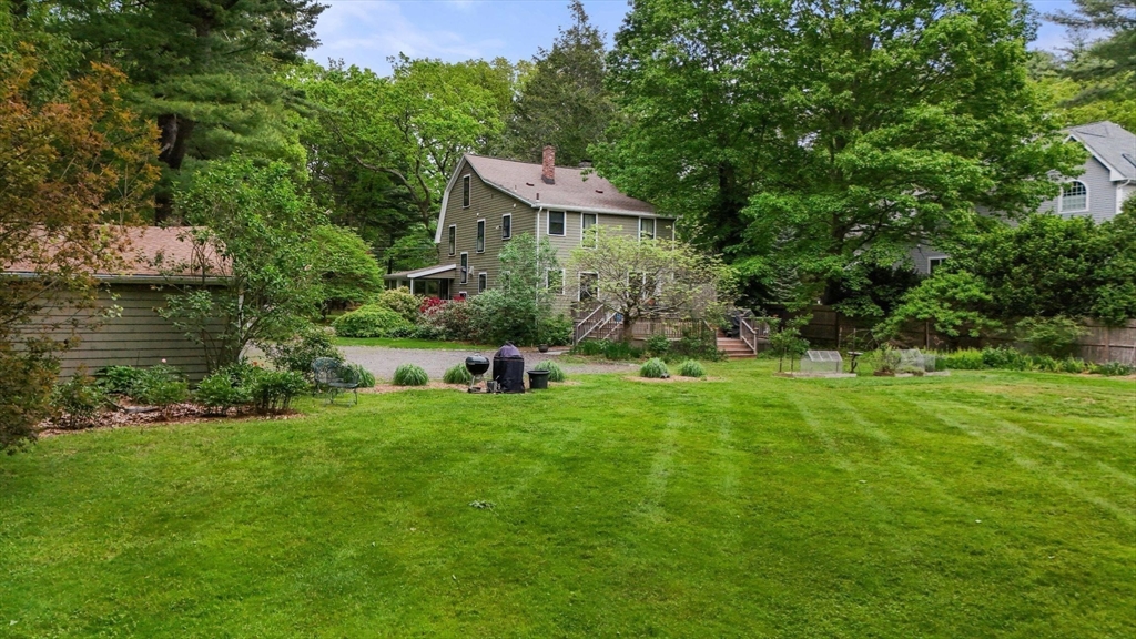 a backyard of a house with lots of green space and lake view