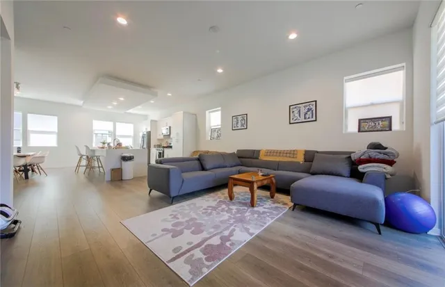 a living room with furniture a rug and a table