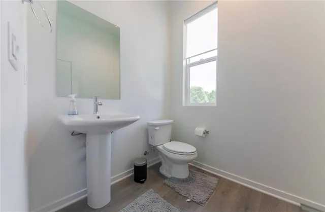 a bathroom with a sink toilet and a mirror