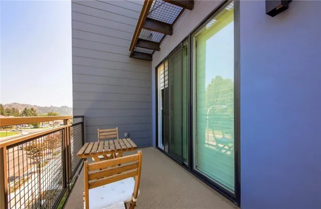 a view of a balcony with furniture and city view