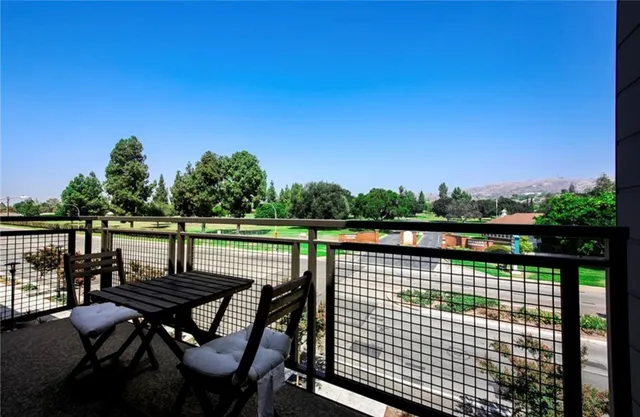 a view of a roof deck with table and chairs