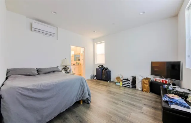 a bedroom with a bed and a flat screen tv