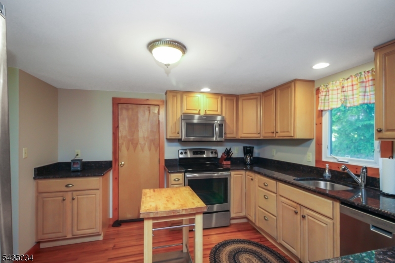 103 Petersburg Road Hackettstown, NJ 07840 - Photo 6 of 18 a kitchen with stainless steel appliances granite countertop a stove a sink and a refrigerator