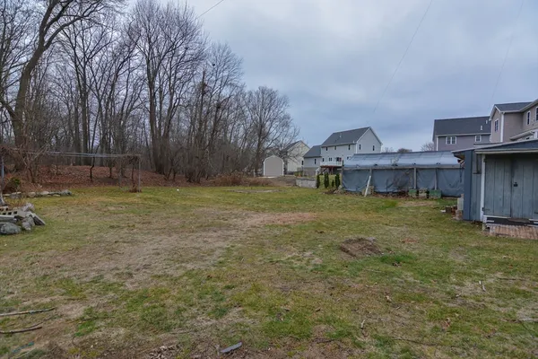 a view of a house with a yard and sitting area