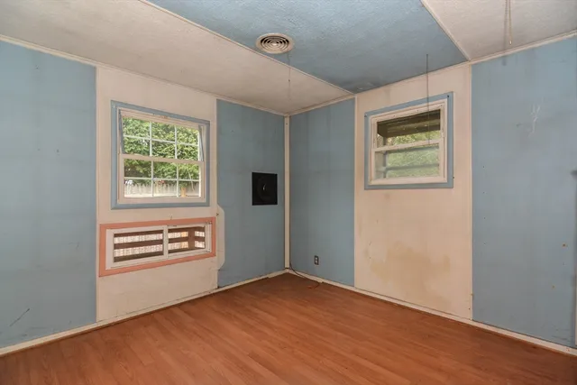 an empty room with windows and closet
