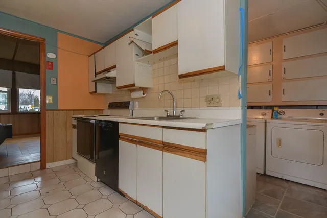 a kitchen with a sink and cabinets
