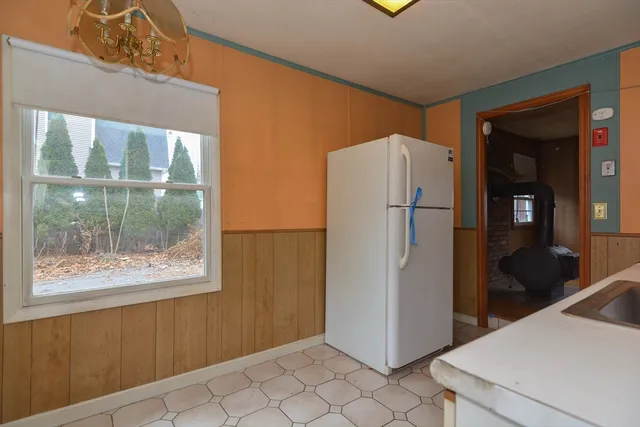 a kitchen with a refrigerator and cabinets