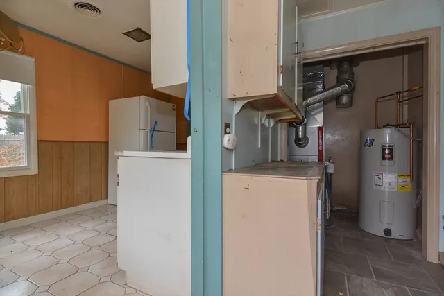 a view of storage and utility room with a refrigerator