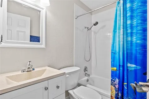 a bathroom with a sink toilet vanity and shower
