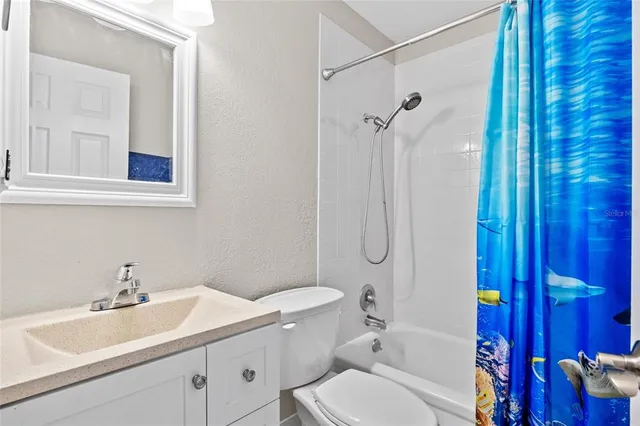 a bathroom with a sink toilet vanity and shower
