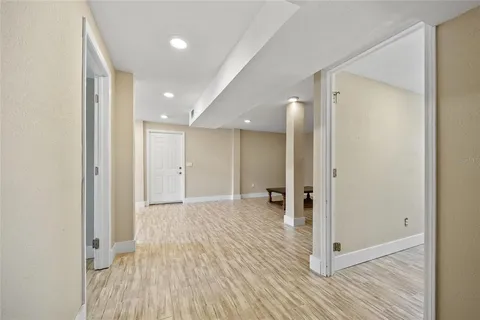 a view of a hallway with wooden floor and closet area