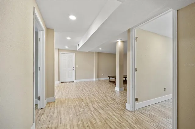 a view of a hallway with wooden floor and closet area