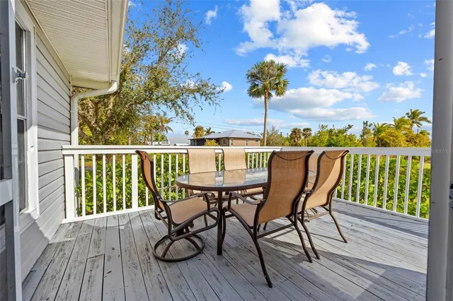 a view of balcony with furniture and wooden floor